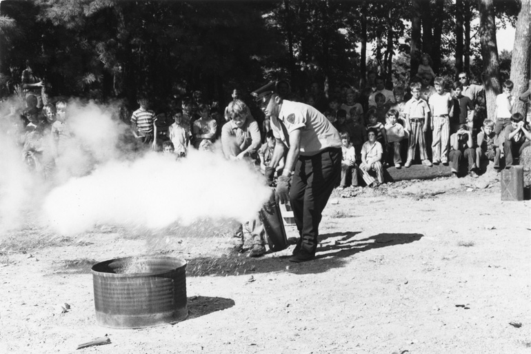 Robert Bennett supervises hands-on practice with a fire extinguisher 
	during an all-day fire safety program