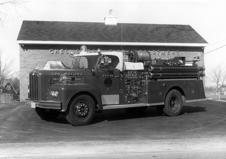 New South Chelmsford Fire Station on Acton Road with the 
		old 750 g.p.m. pumper from the Center parked in front